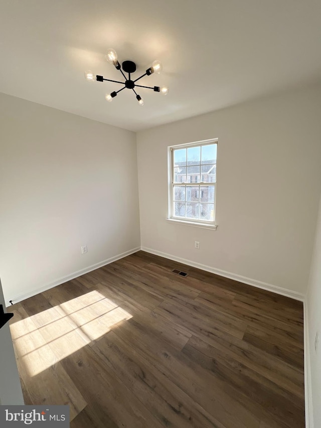 empty room featuring dark wood-type flooring