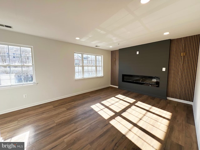 unfurnished living room featuring dark hardwood / wood-style flooring