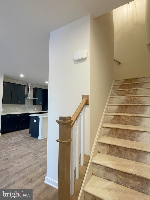 stairway with hardwood / wood-style flooring