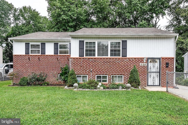 raised ranch with a front yard