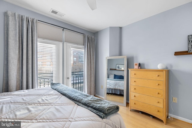 bedroom featuring access to exterior, ceiling fan, and light hardwood / wood-style floors