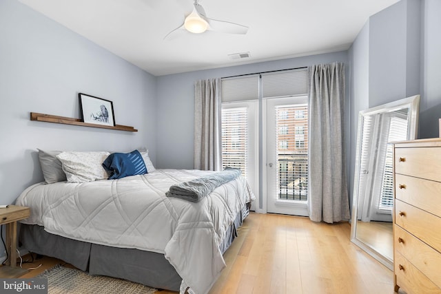 bedroom featuring access to exterior, ceiling fan, and light hardwood / wood-style flooring