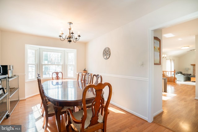 dining area with a chandelier and light hardwood / wood-style floors