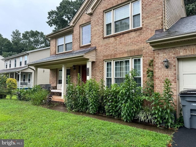 view of front of house featuring a front yard and covered porch