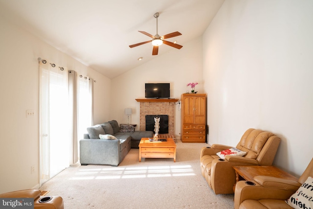 living room with ceiling fan, light colored carpet, high vaulted ceiling, and a brick fireplace