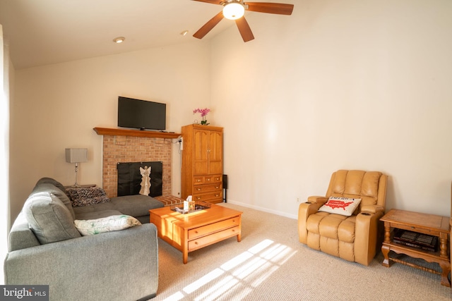 carpeted living room featuring lofted ceiling, ceiling fan, and a brick fireplace