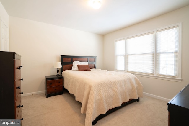 bedroom featuring light carpet