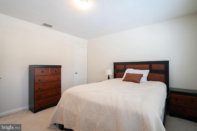 bedroom featuring light colored carpet