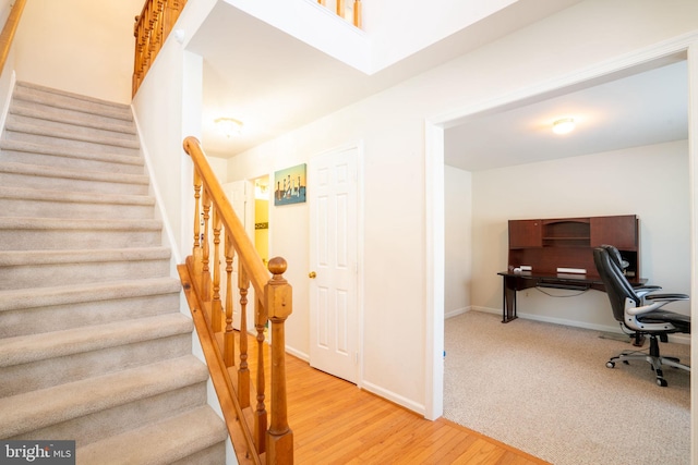 stairs featuring hardwood / wood-style flooring