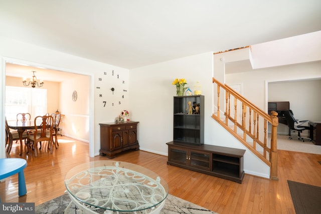 living room featuring wood-type flooring and a chandelier