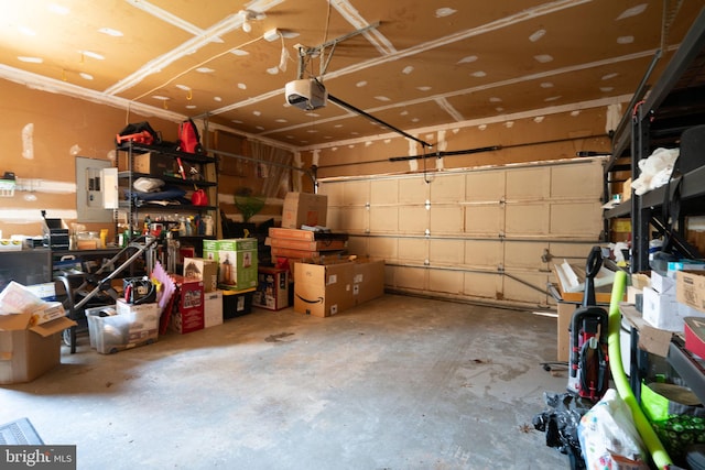 garage with a garage door opener and electric panel