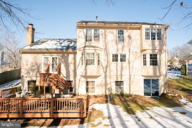 back of property with central AC unit and a deck