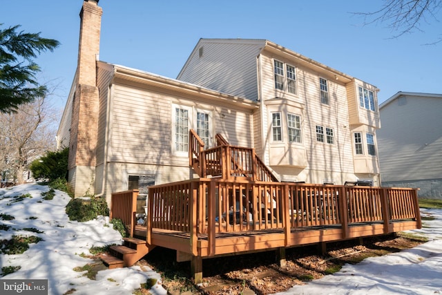 snow covered property featuring a deck