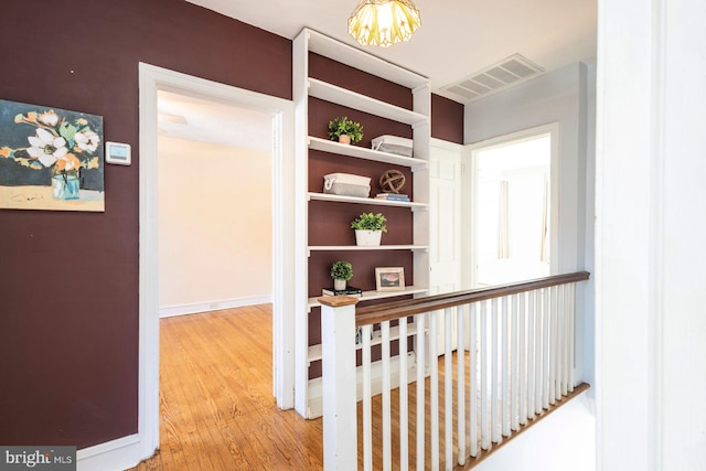 hall with hardwood / wood-style floors