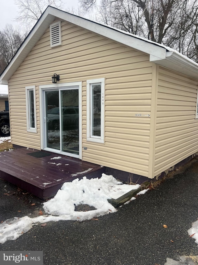 view of snow covered exterior with a deck