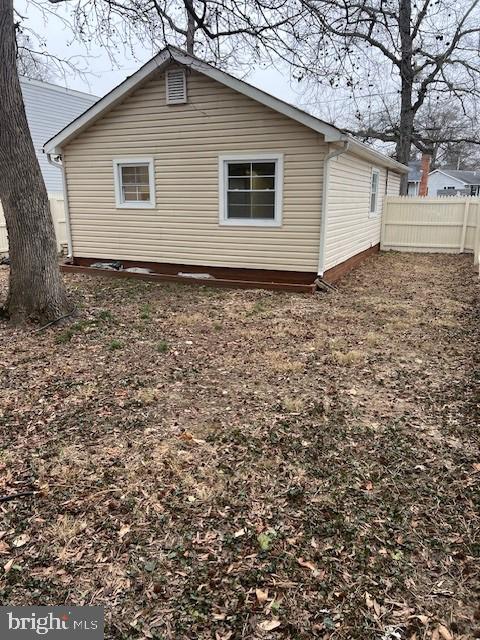 back of house featuring fence