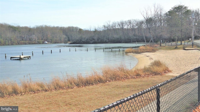 water view featuring fence and a forest view