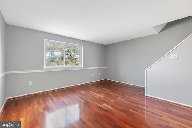 unfurnished room with hardwood / wood-style flooring