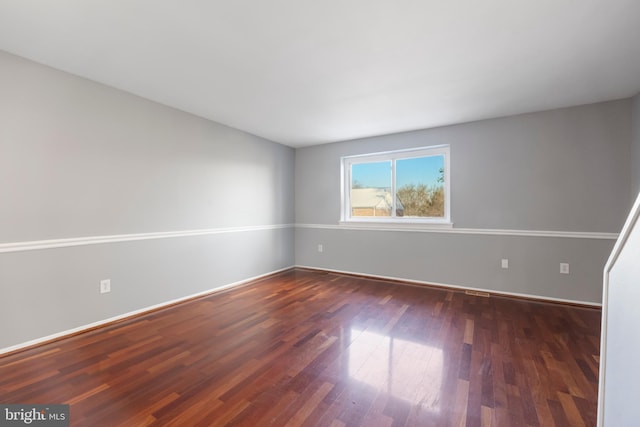 spare room with dark hardwood / wood-style floors