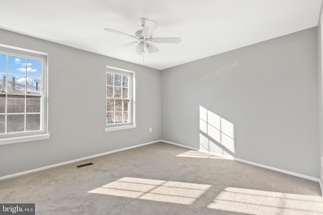 carpeted empty room featuring ceiling fan