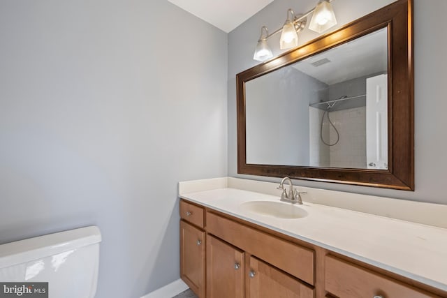 bathroom with a shower, toilet, and vanity