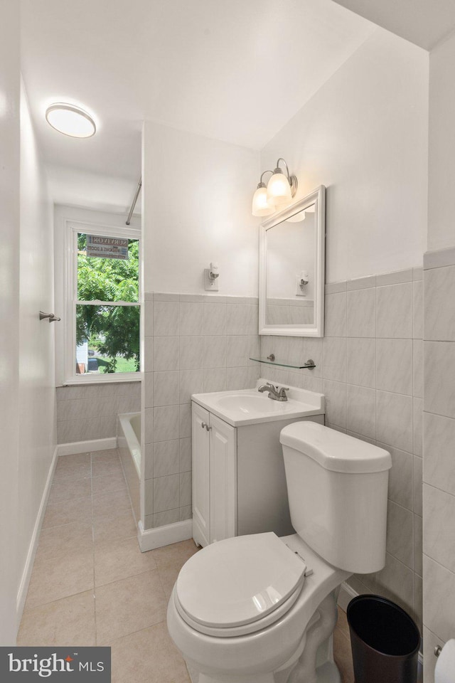 bathroom featuring tile walls, toilet, vanity, and tile patterned flooring