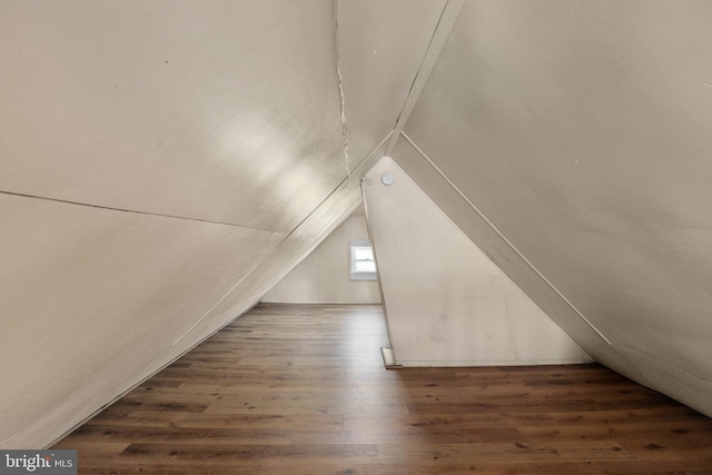 bonus room featuring dark hardwood / wood-style flooring and lofted ceiling