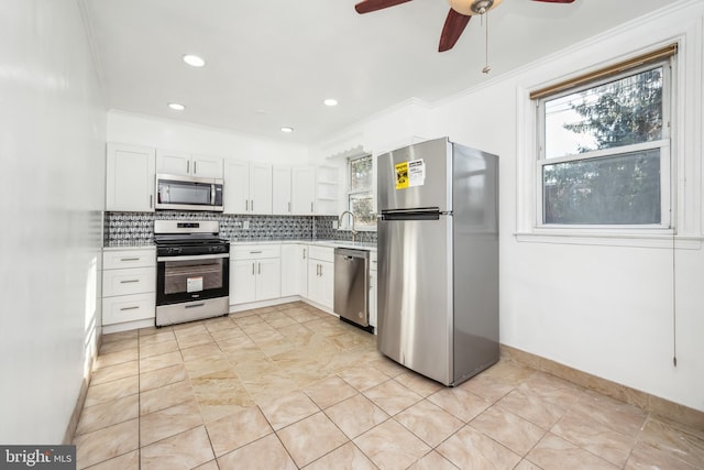 kitchen featuring white cabinetry, sink, backsplash, and stainless steel appliances