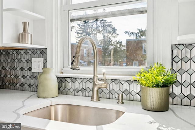 room details with light stone countertops and sink