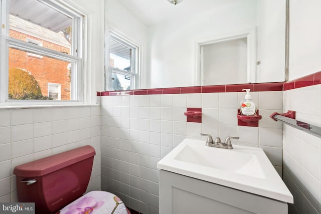 bathroom featuring vanity and tile walls