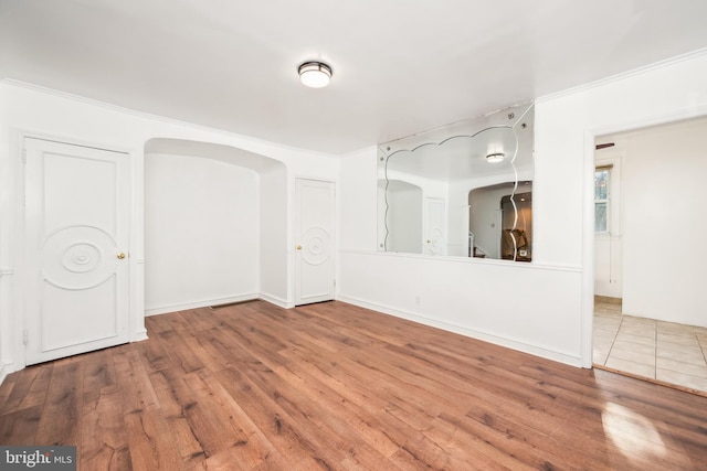 unfurnished room featuring hardwood / wood-style flooring and crown molding