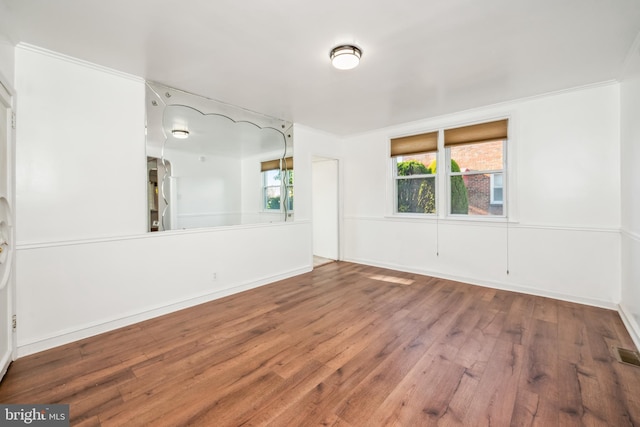 unfurnished room featuring crown molding and hardwood / wood-style flooring