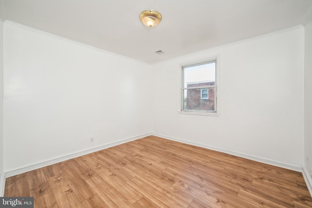 unfurnished room with crown molding and hardwood / wood-style floors