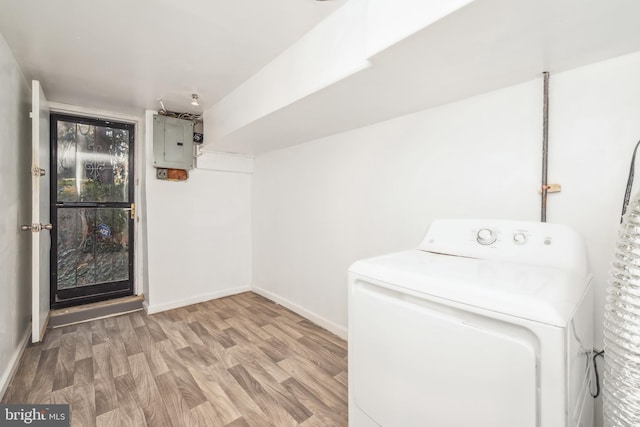 laundry room featuring electric panel, washer / dryer, and wood-type flooring