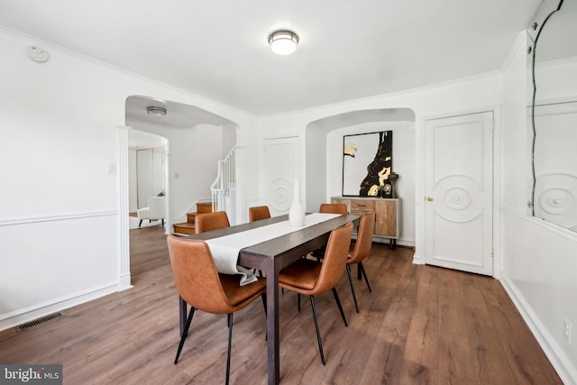 dining room featuring hardwood / wood-style flooring and crown molding