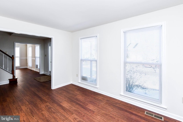 spare room with dark hardwood / wood-style flooring