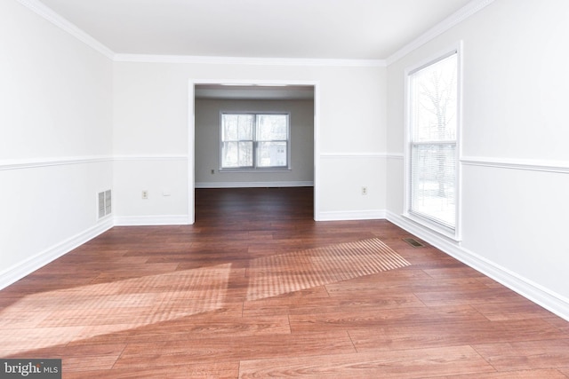 unfurnished room featuring dark wood-type flooring and crown molding