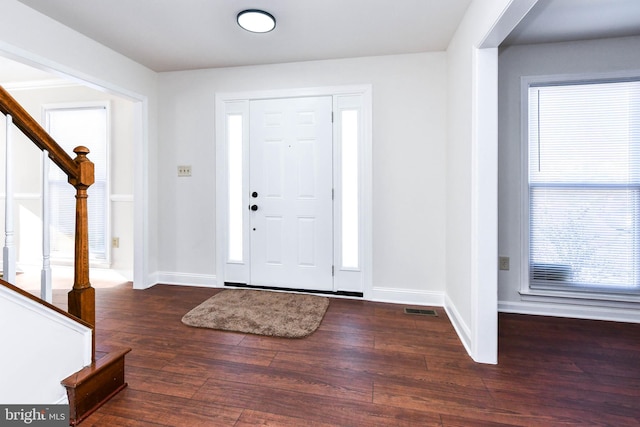 foyer entrance with dark hardwood / wood-style floors