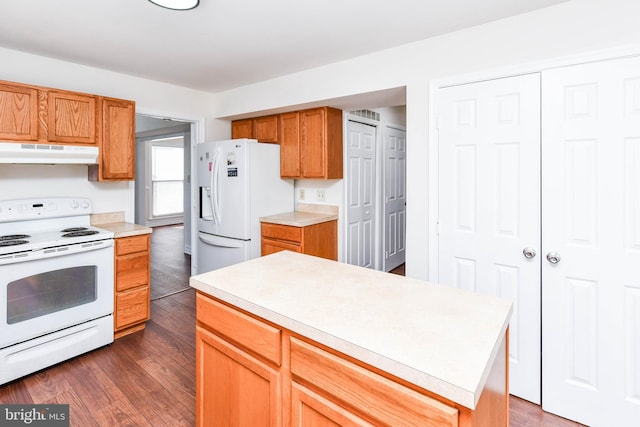 kitchen featuring a center island, white appliances, and dark hardwood / wood-style flooring