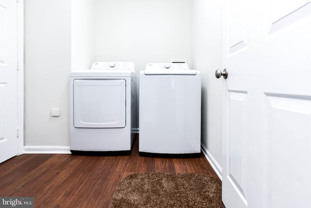 clothes washing area with separate washer and dryer and dark hardwood / wood-style floors