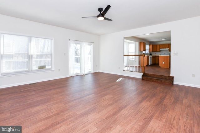 unfurnished living room with hardwood / wood-style flooring and ceiling fan