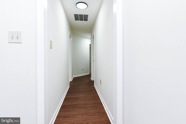 corridor featuring dark wood-type flooring