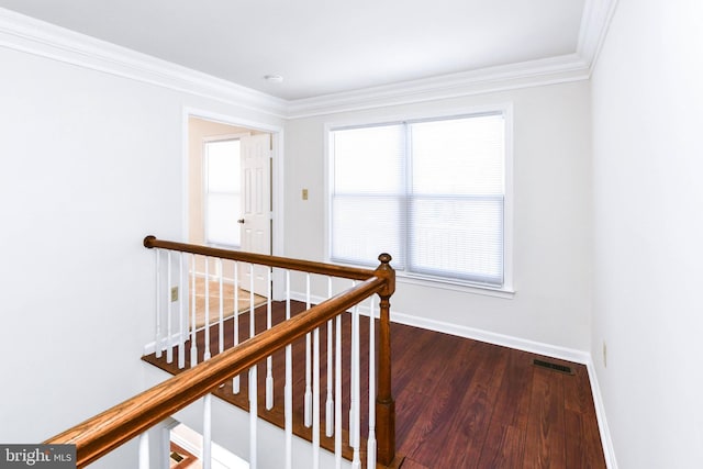 stairs with crown molding and hardwood / wood-style flooring