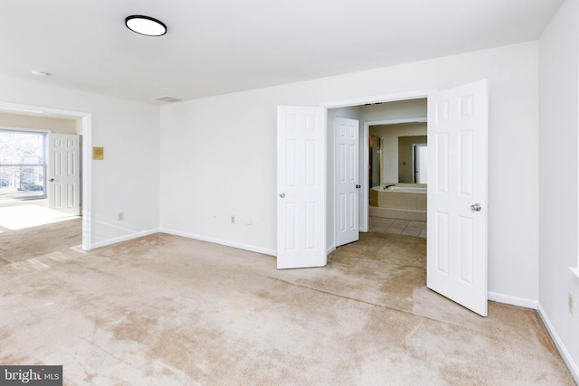 unfurnished room featuring light colored carpet