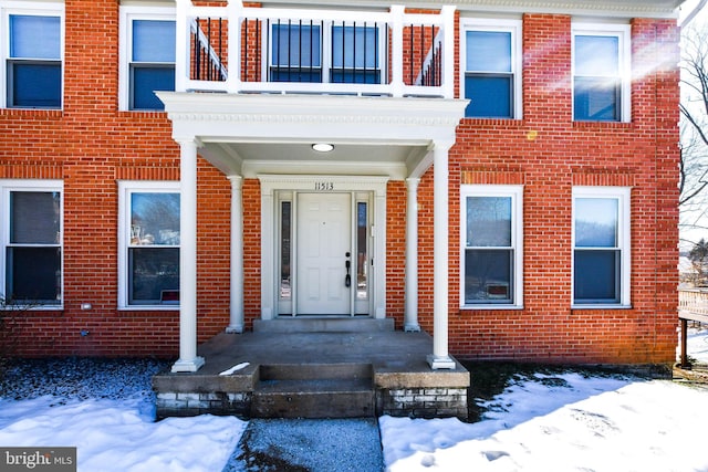 view of snow covered property entrance