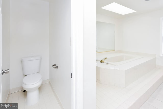 bathroom featuring toilet, tile patterned flooring, and a skylight