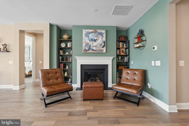 living area with hardwood / wood-style floors