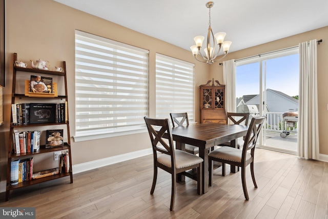 dining room with an inviting chandelier and light hardwood / wood-style floors