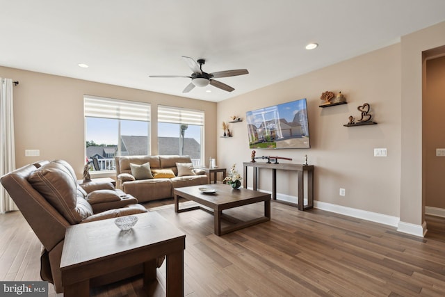 living room featuring ceiling fan and hardwood / wood-style floors