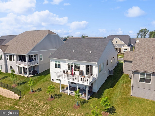 rear view of house with a patio and a balcony